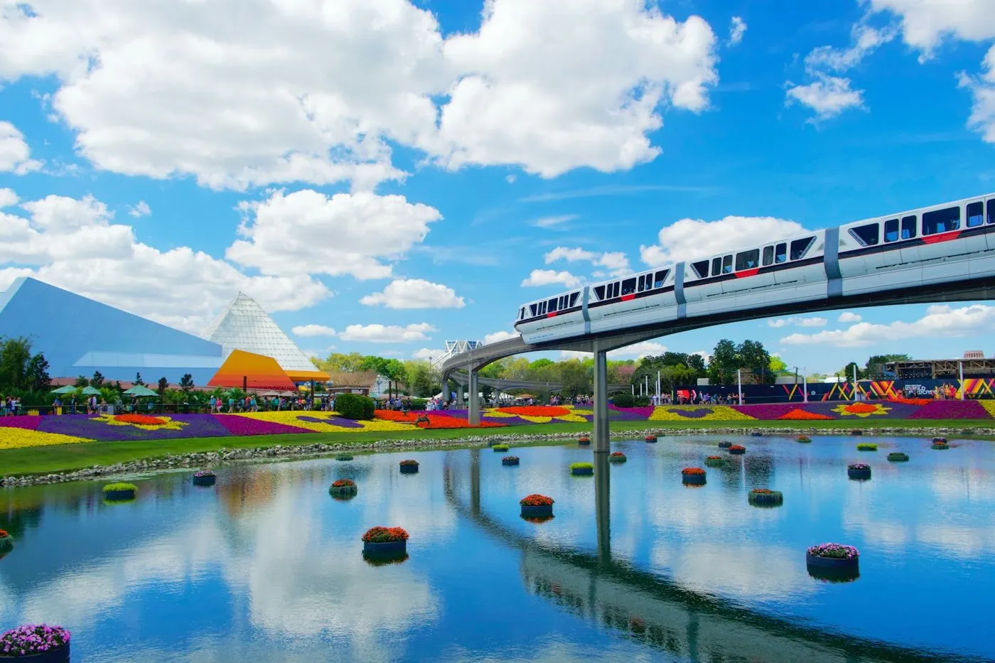 The EPCOT monorail passing spring flower beds at Walt Disney World