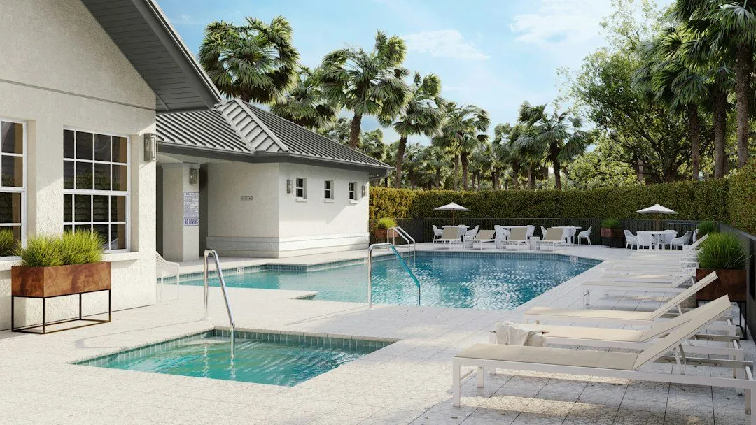 A luxurious pool area with sun loungers and building